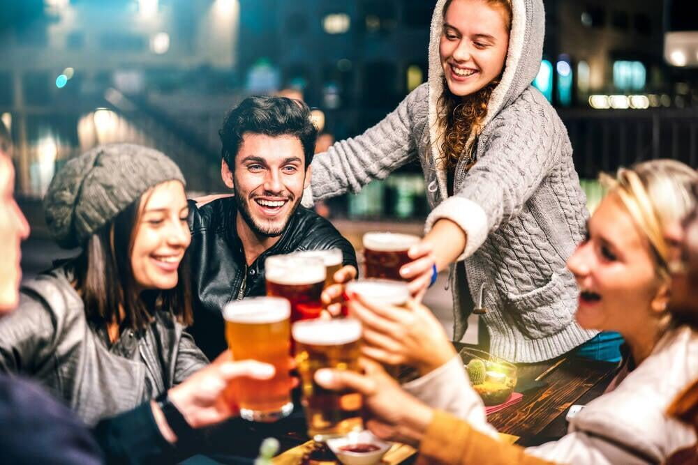 Happy people drinking beer at brewery